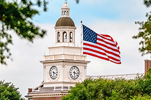graduate school in Dallas - patriotic building with American flag flying in the sky