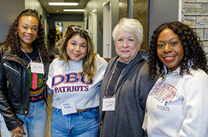 group of alumni standing with a professor in Dallas, Texas