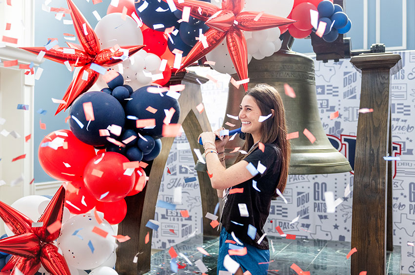 New Patriot ringing a replica of the Liberty Bell on a college campus in Dallas, Texas