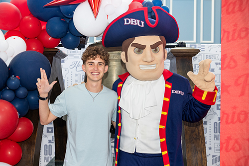 Jackson Davis standing by the Patriot Man at New Patriot Orientation