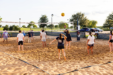 college students playing volleyball outside in Dallas, Texas