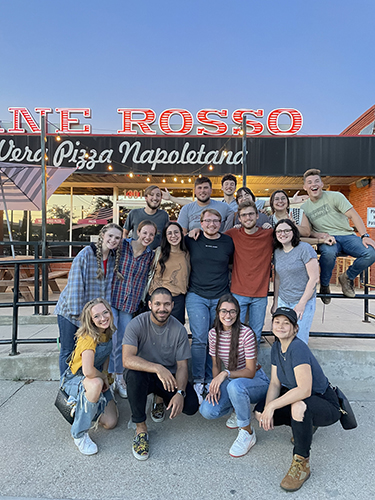 group photo of coffeehouse team outside traveling