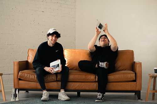 business partners Joseph Arze and Andy Norton sitting on a couch