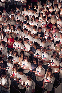 Christian college students in Dallas, Texas holding candles as part of the SWAT traditions