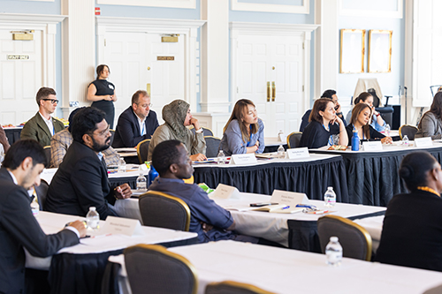 Audience sitting around tables in the Great Hall